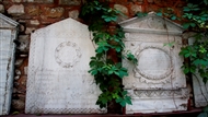 Στον αυλόγυρο της Παναγίας Καφφατιανής (το 2013): Δυο μαρμάρινες ταφόπλακες με τη μορφή πρόσοψης αρχαίου οικίσκου